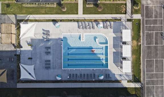 an aerial view of a swimming pool in a city