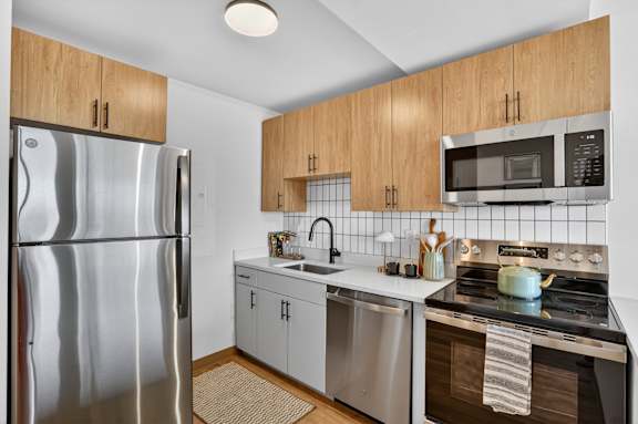 Modern kitchen with a stainless steel refrigerator and oven at Reflections at the Wharf, Washington, DC, District of Columbia