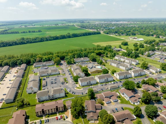 an aerial view of a neighborhood of houses and cars in a parking lot at Candles, Illinois, 62704