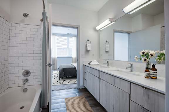 Bathroom with mirror and sink at 747 Apartments, Indiana, 46202