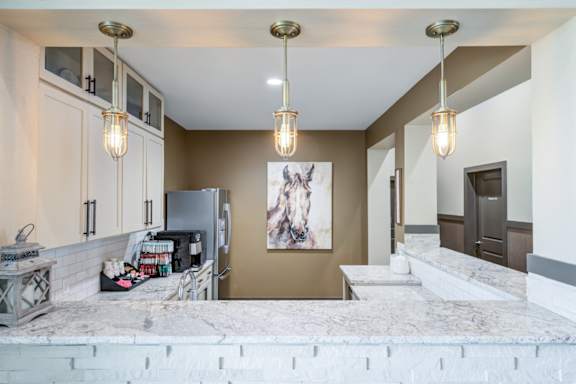 Complimentary coffee bar at Adara apartments with modern self-serve espresso machine and stylish resident lounge.