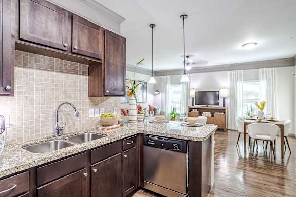 Kitchen with wood cabinets at Avenues at Shadow Creek Ranch Apartments, Pearland, TX