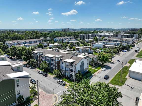 A sunny day in a residential area with cars parked on the side of the road. at CityView, Missouri