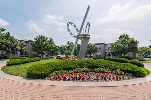 A large sculpture in the shape of a heart is surrounded by a circular garden with red flowers. at CityView, Missouri