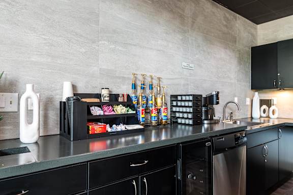 A kitchen with black cabinets and a grey countertop. at CityView, North Kansas City, Missouri
