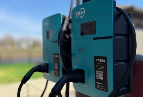 Two electric vehicle charging stations are shown up close at Avenues at Shadow Creek Ranch Apartments, Pearland, Texas