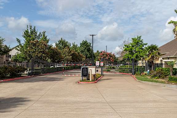 Sunny day at the entrance of a gated community at Grand Villas at Cinco Ranch, Texas