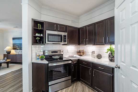 Kitchen with stove top oven at Grand Villas at Cinco Ranch, Katy, TX, 77494
