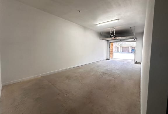 A long empty room with a window.