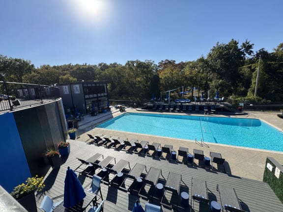 an aerial view of a swimming pool and deck with chairs at The Boulevard, Roeland Park, KS, 66205