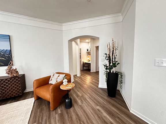 A living room with a brown chair and a brown ottoman.