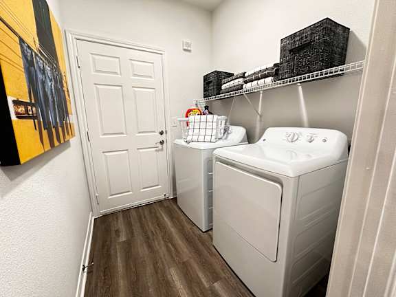 A small laundry room with a washer and dryer.