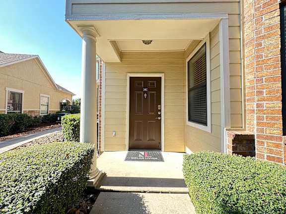 A house with a brown door and a sign that says