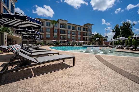 Pool Area with Sun Loungers at Imperial Lofts, Sugar Land
