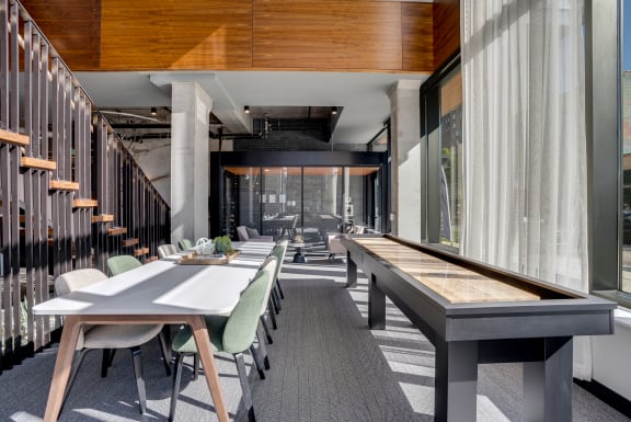 a large dining area with tables and chairs and a shuffleboard at Marquee, Minneapolis, Minnesota
