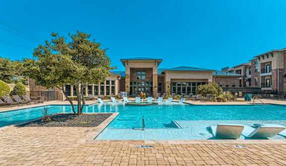 a large swimming pool with a building in the background at Discovery at Craig Ranch, McKinney, TX, 75070