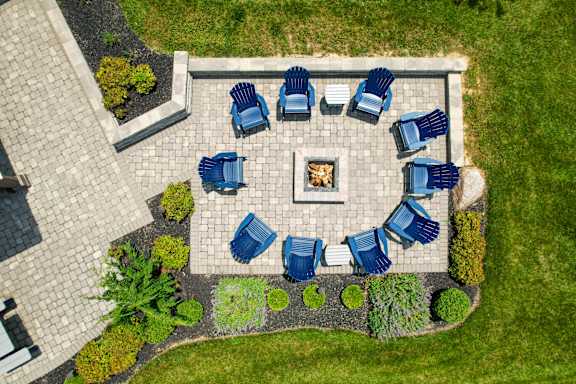 A fire pit surrounded by blue chairs in a garden. at Overland Park, Pickerington, OH, 43147