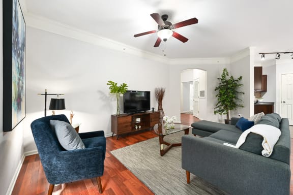 a living room with furniture and a ceiling fan at Sovereign at Overland Park, Overland Park