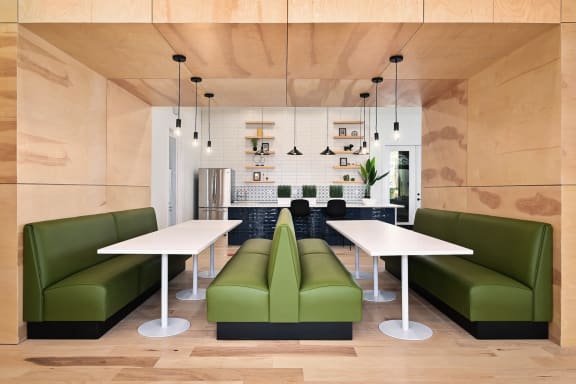 a living room with green couches and a white table at Sovereign at Overland Park, Kansas, 66213