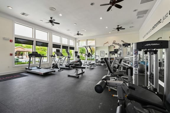 the gym is equipped with state of the art gym equipment and windows at Sovereign at Overland Park, Overland Park
