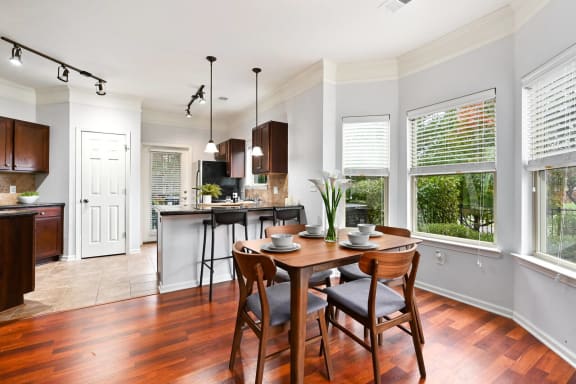 an open kitchen and dining room with a table and chairs at Sovereign at Overland Park, Overland Park, KS