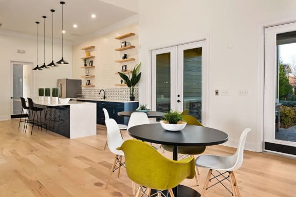 a kitchen and dining area with a table and chairs at Sovereign at Overland Park, Overland Park, KS