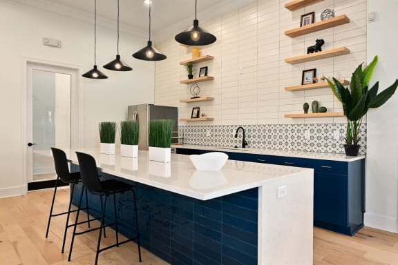 a kitchen with a large white counter top and blue cabinets at Sovereign at Overland Park, Overland Park, 66213