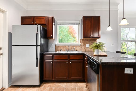 a kitchen with a refrigerator and a sink at Sovereign at Overland Park, Overland Park, KS
