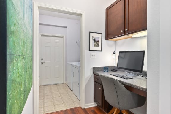 a home office with a computer desk and a door to a bathroom at Sovereign at Overland Park, Overland Park, KS 66213