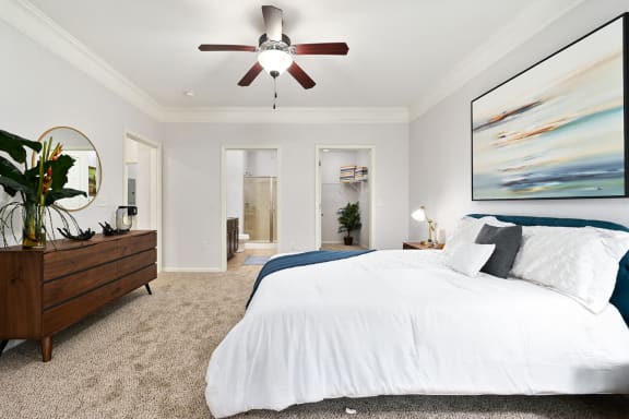 a bedroom with a large bed and a ceiling fan at Sovereign at Overland Park, Overland Park Kansas