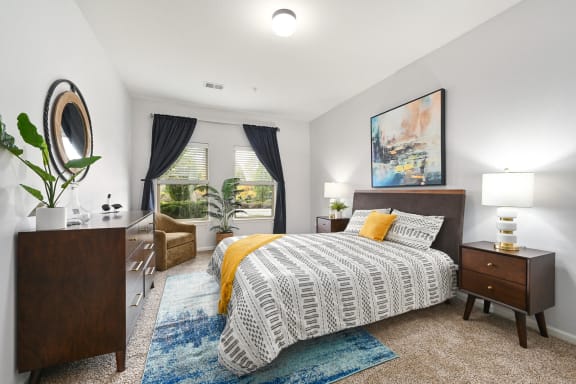 a bedroom with a bed and a window at Sovereign at Overland Park, Kansas