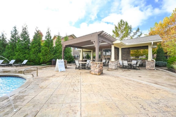 a patio with a pool and chairs and a pavilion at Sovereign at Overland Park, Overland Park, KS
