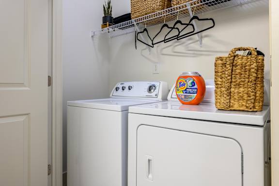 A white washing machine and dryer in a small laundry room. at Penn Circle, Indiana