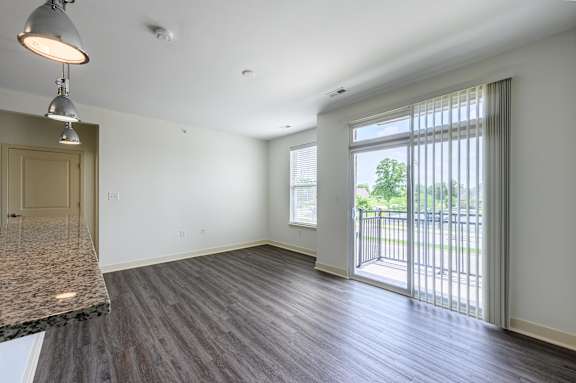 A spacious room with a marble countertop and wooden flooring. at Penn Circle, Carmel, 46032