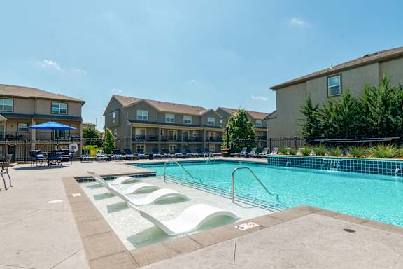 A swimming pool with a slide in the middle of it.