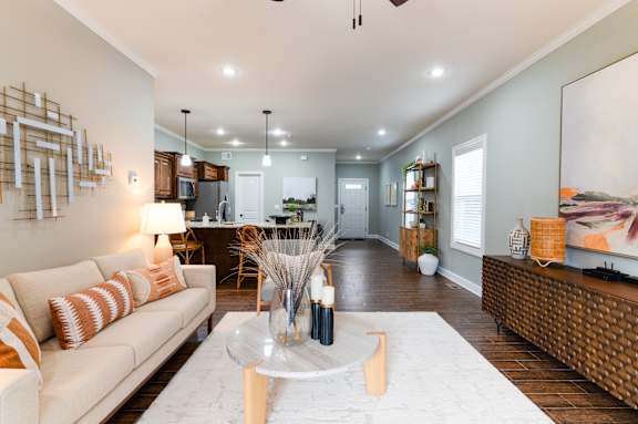 A modern living room with a white sofa and a coffee table.