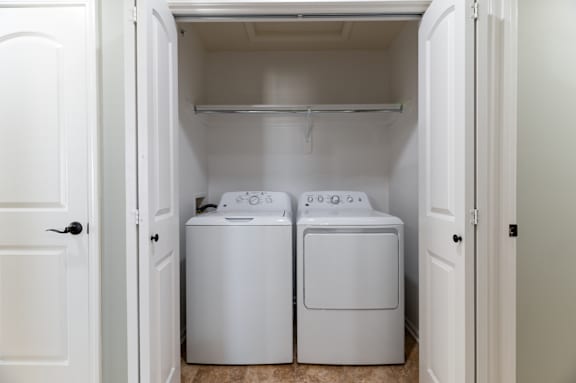 A small laundry room with a washer and dryer.
