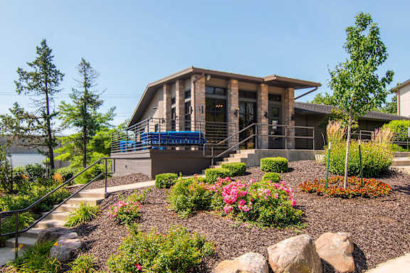 A modern house with a garden in front.
