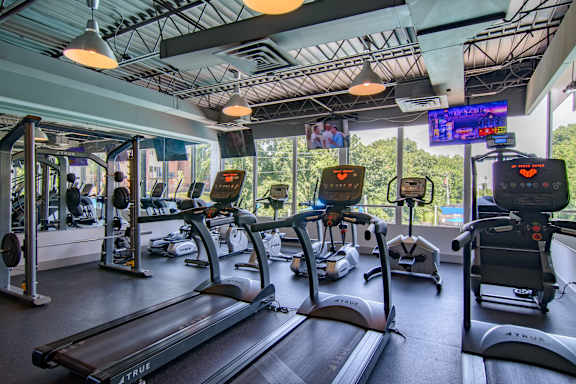 A gym with treadmills and other exercise equipment.