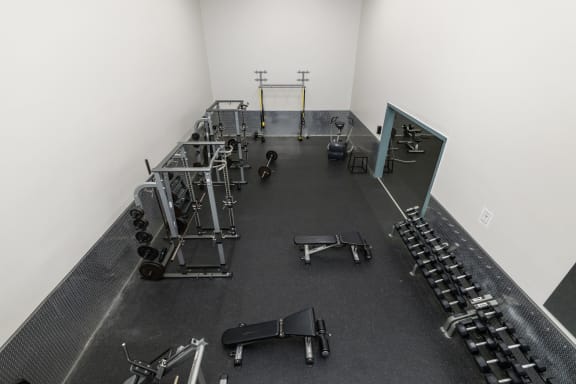 a gym with weights and cardio equipment in a white room at Candles, Springfield, IL, 62704