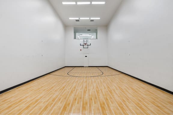 the inside of an empty room with a basketball court at Candles, Springfield, IL