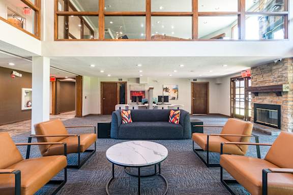 A large room with a fireplace and a couch.