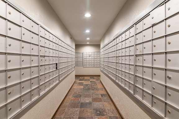 A long hallway with a row of mailboxes on each side.