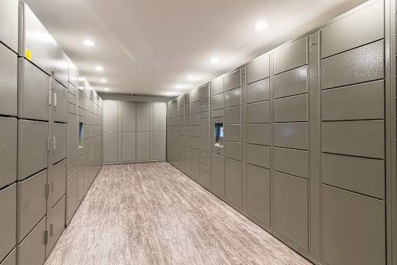 A long hallway with a series of lockers on the wall.
