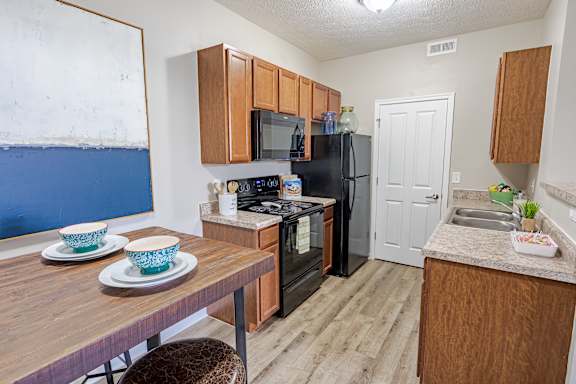 A kitchen with a refrigerator, microwave, oven, and sink. at The Greyson, Ohio, 43026