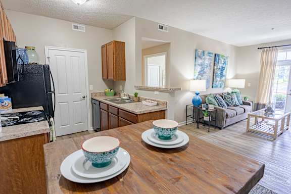 A kitchen with a black fridge and wooden countertops. at The Greyson, Ohio