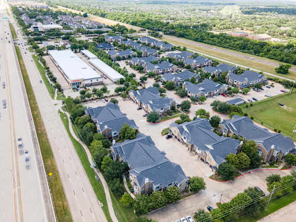 A suburban neighborhood with houses and a road at Waterstone at Cinco Ranch Apartments, Katy, TX