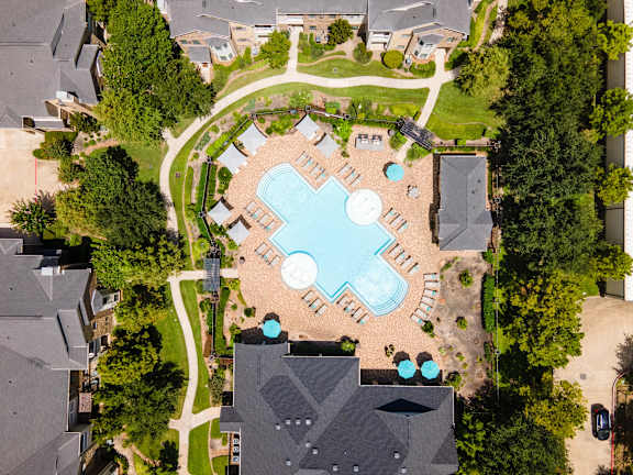 A bird's eye view of a community with a large swimming pool in the center at Waterstone at Cinco Ranch Apartments, Katy, TX 77450
