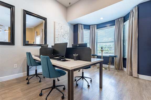 A room with a desk, chairs, and a mirror at Waterstone at Cinco Ranch Apartments, Texas, 77450