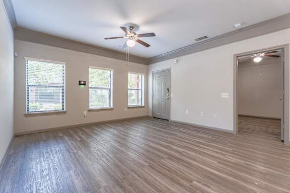 A room with a ceiling fan and wooden flooring at Waterstone at Cinco Ranch Apartments, Katy, 77450